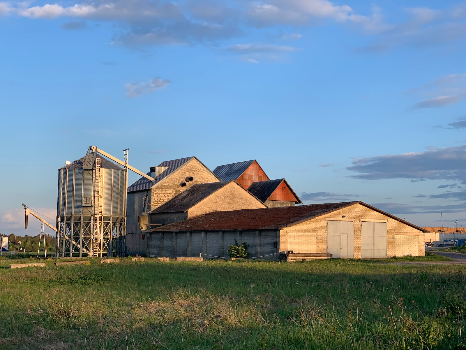 Grain storage silos and warehouse complex at golden hour